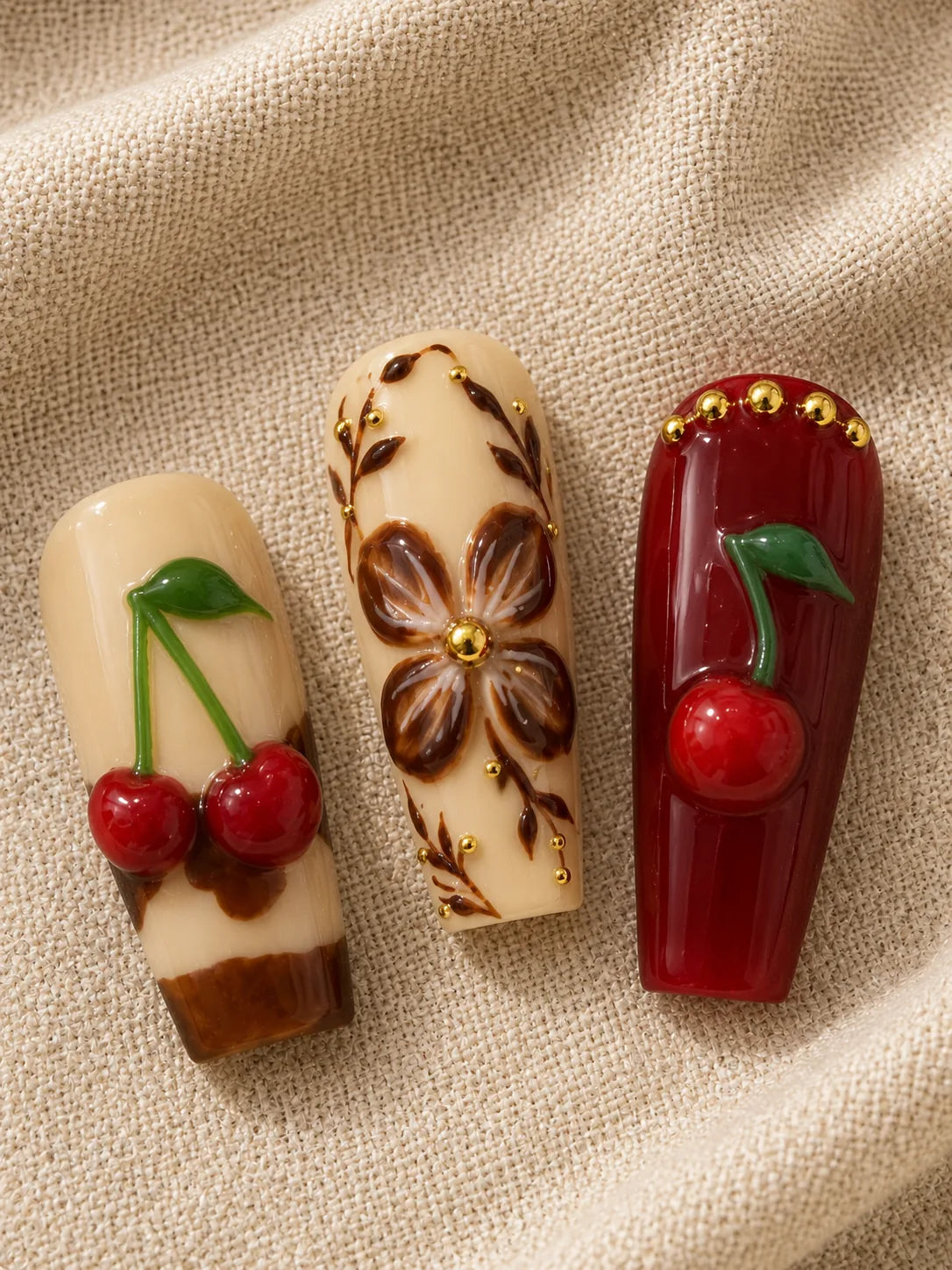Cherry Cola Bloom Gold Stud Press-On Nails - closeup