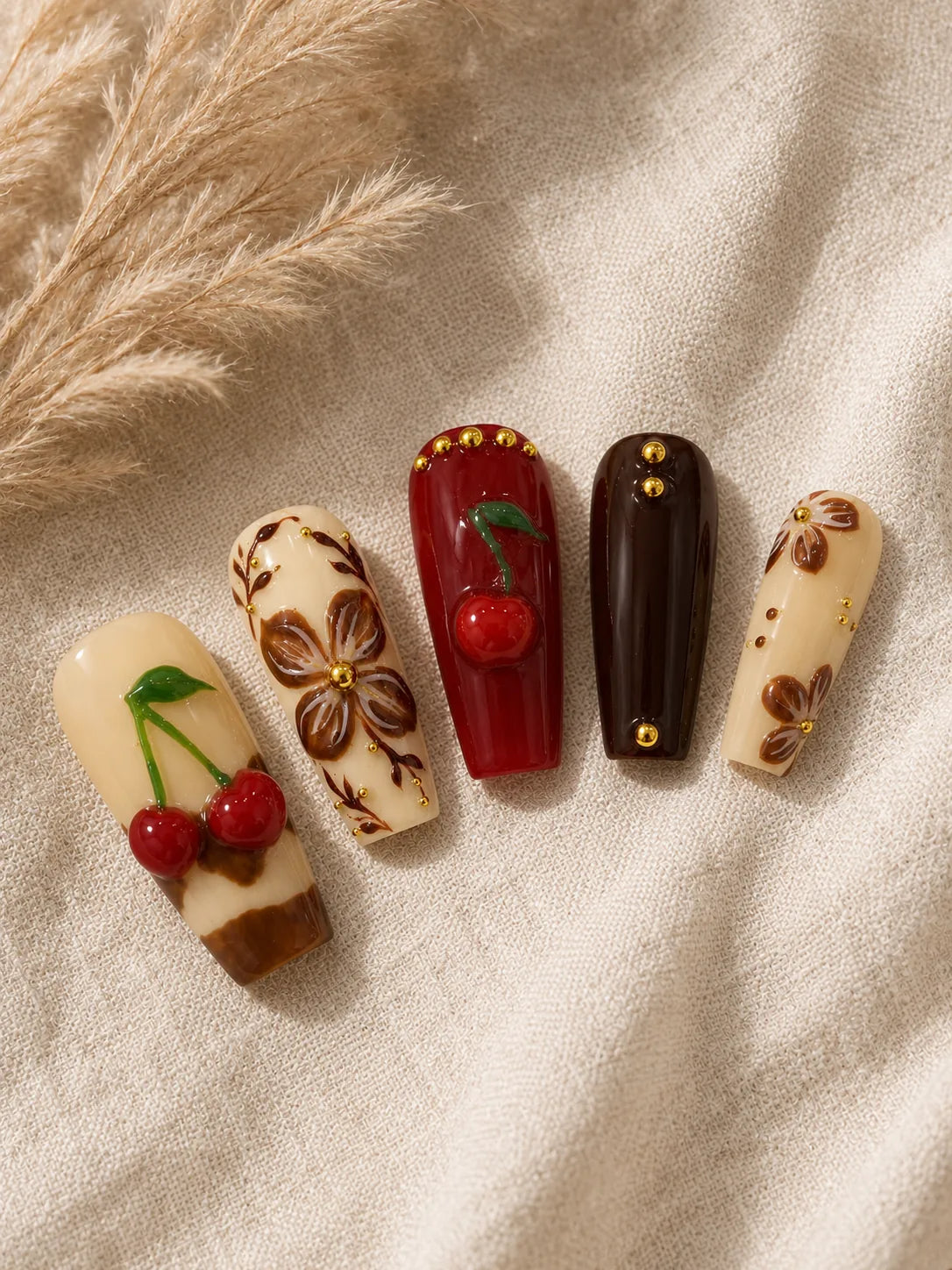 Cherry Cola Bloom Gold Stud Press-On Nails - closeup2