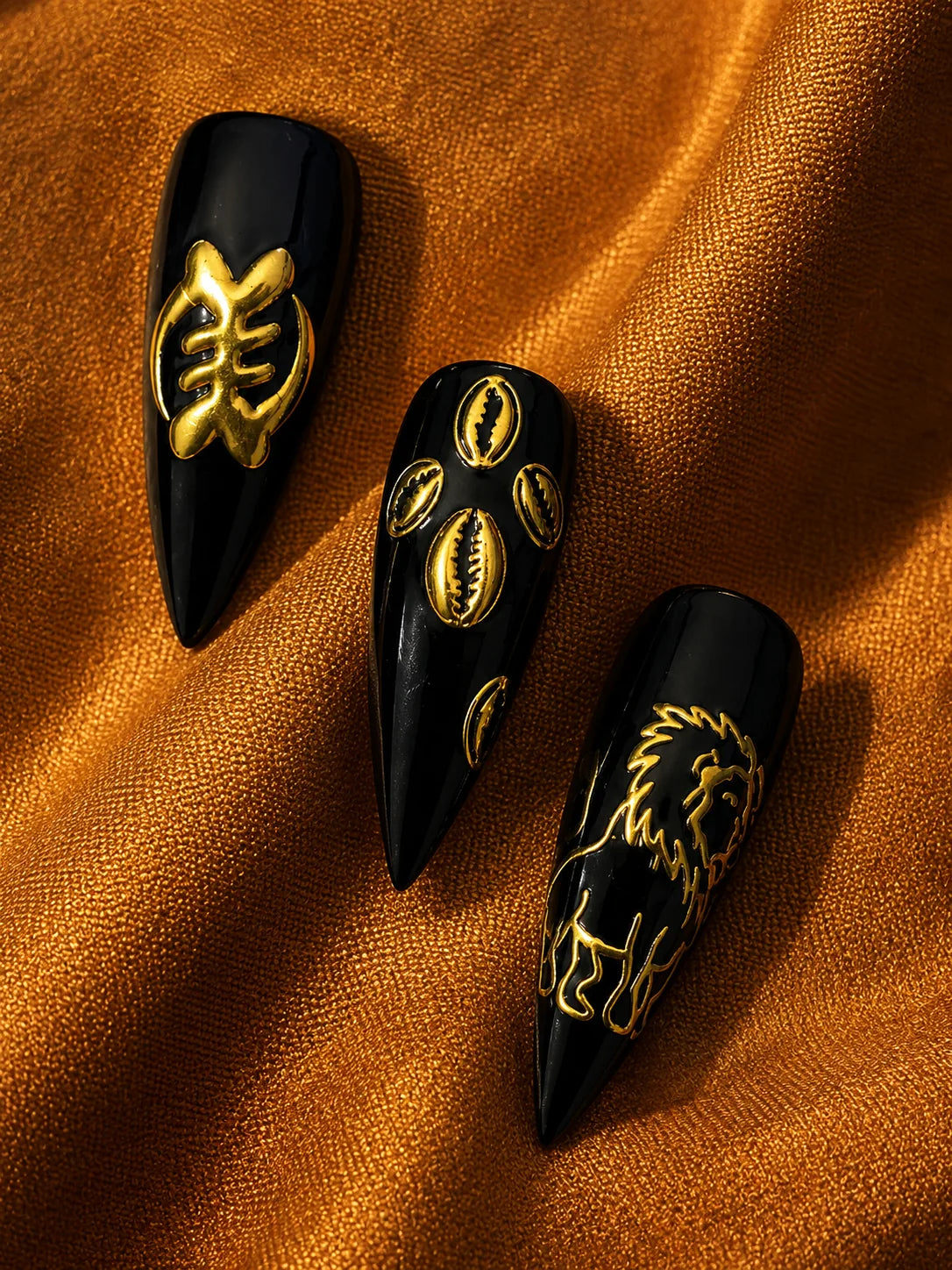 Lion Cowrie - Gold Relief Black Press-On Nails - closeup