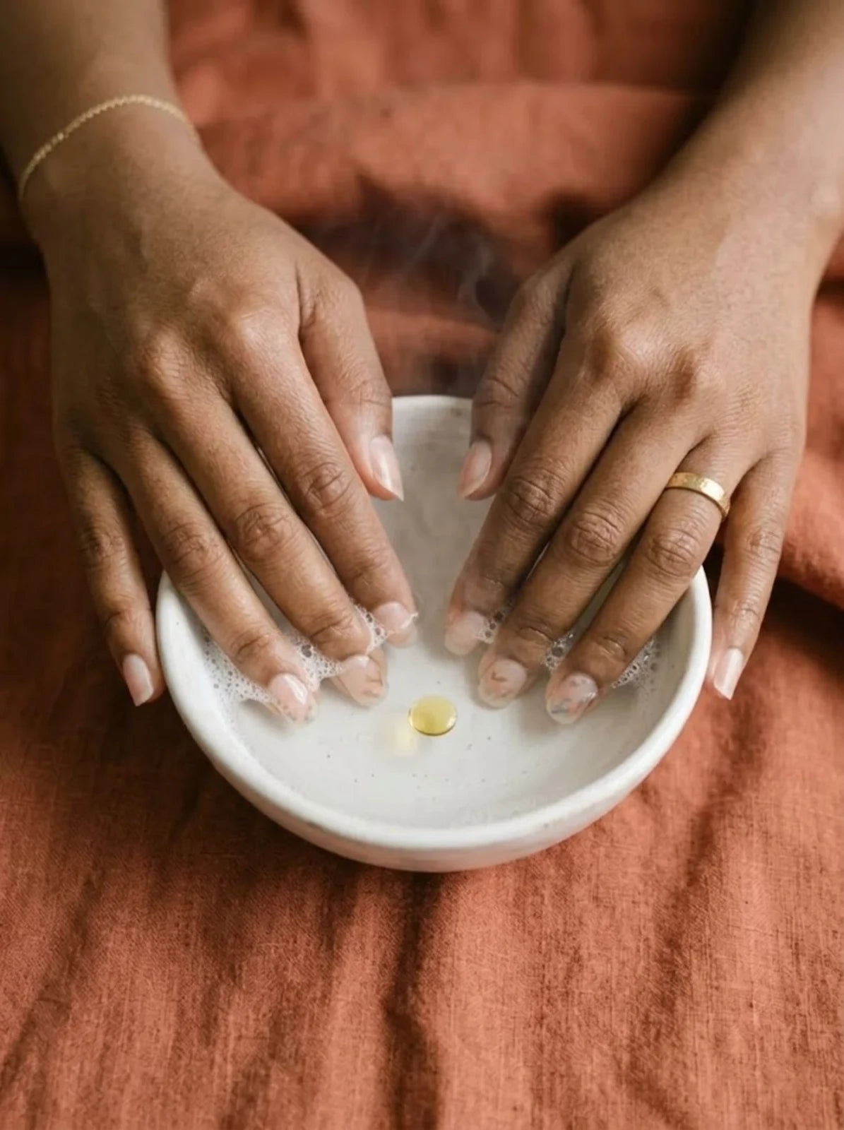 Soak fingertips in warm soapy water with cuticle oil