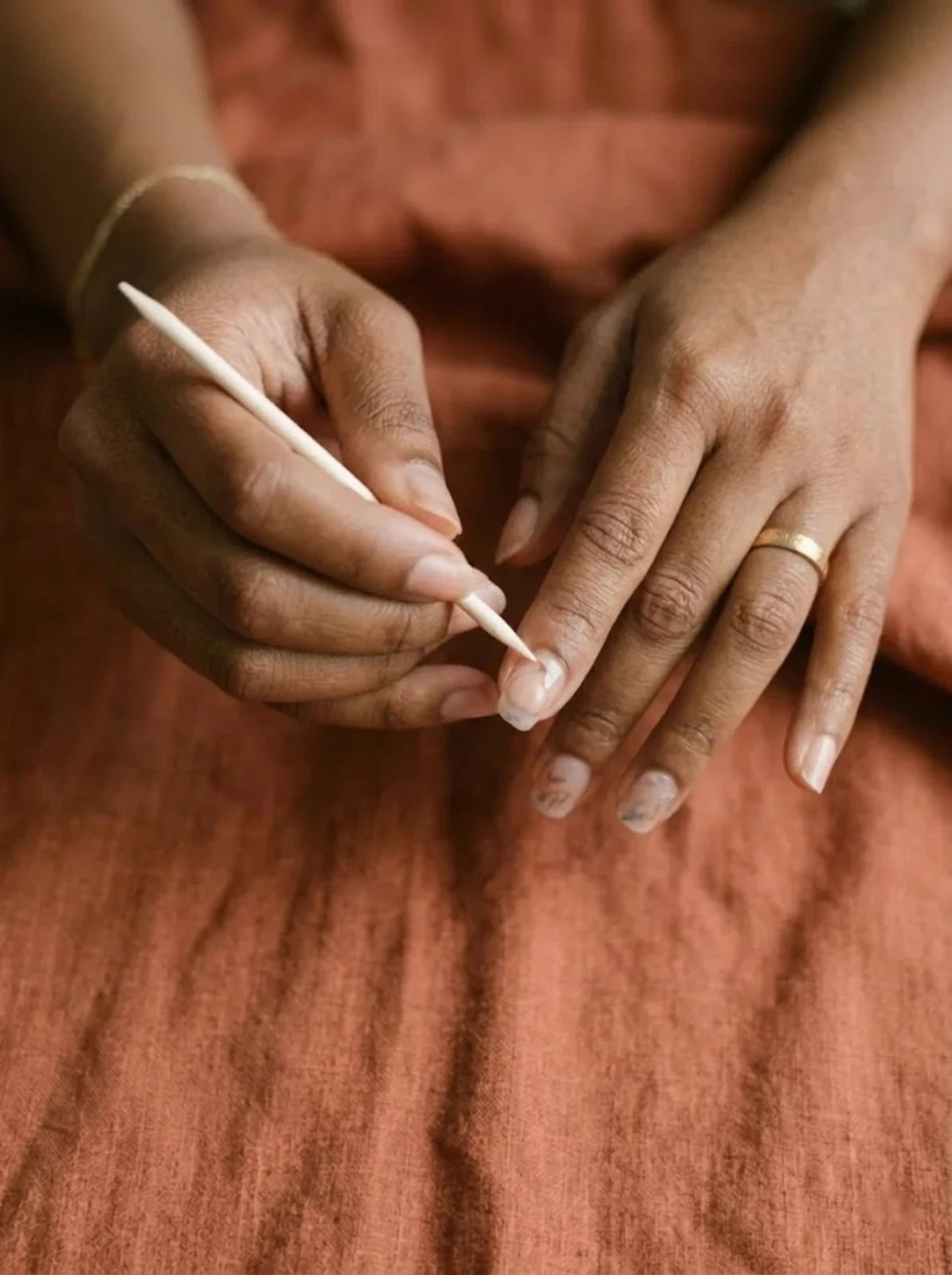Lift the press-on edge with a wooden cuticle stick