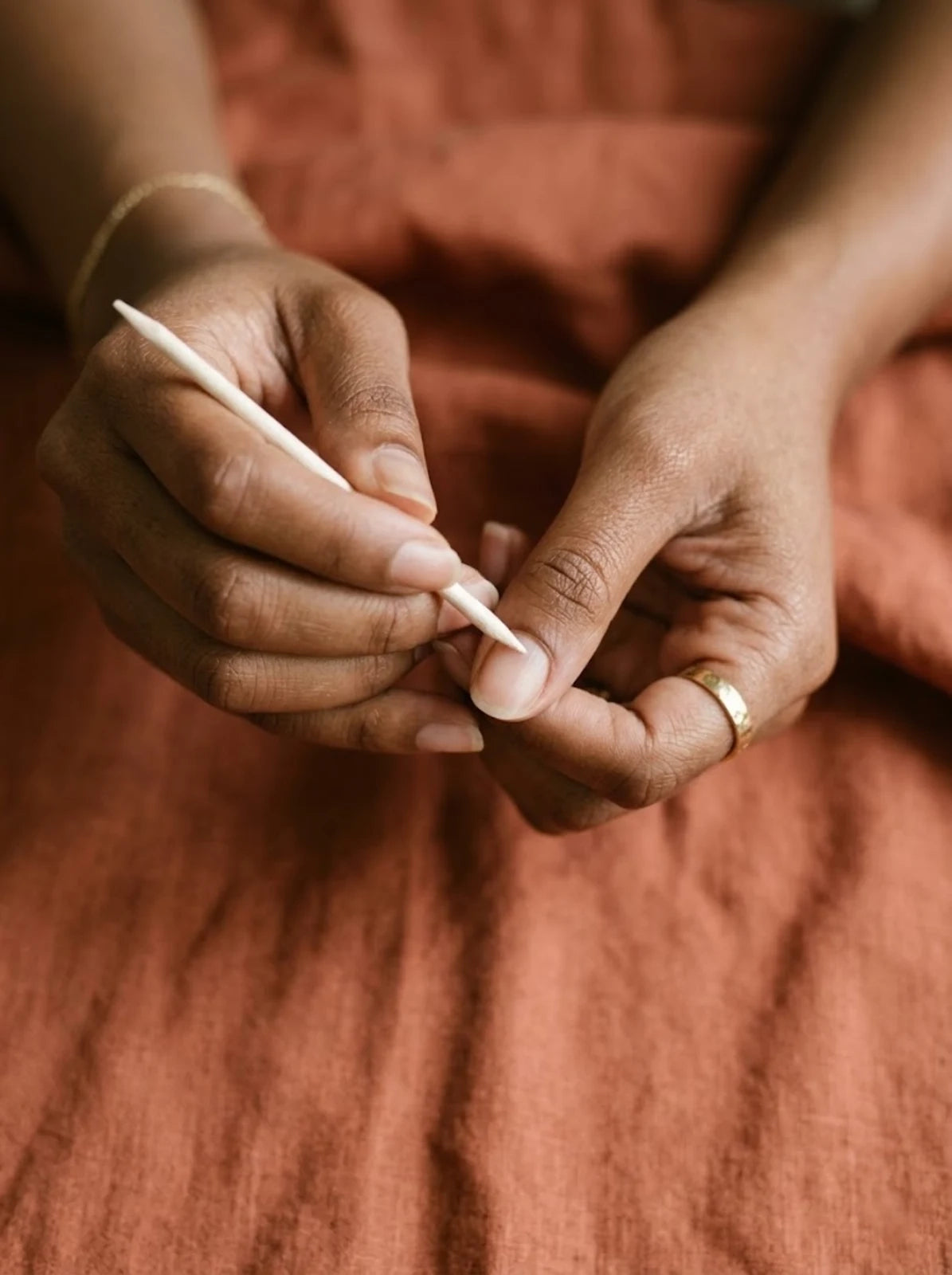 Push back cuticles gently with the wooden stick