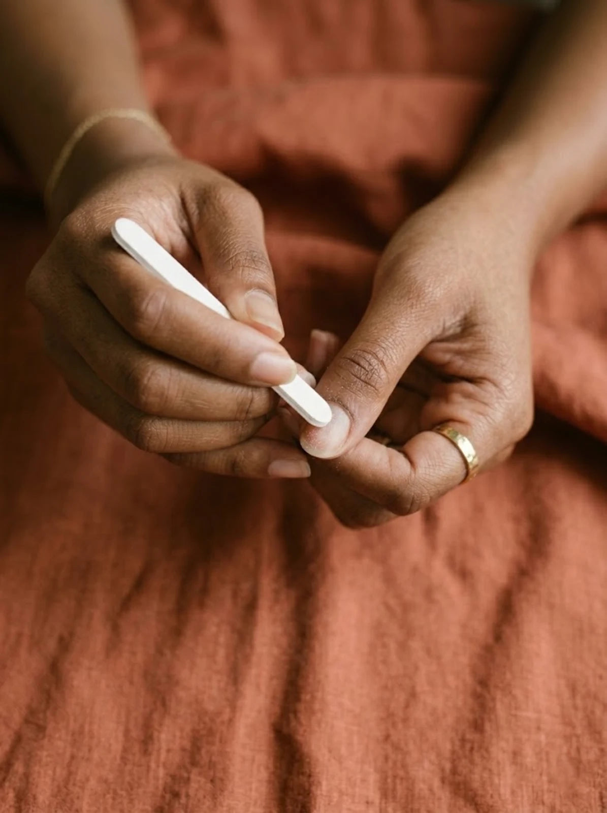 File and buff natural nails to remove shine